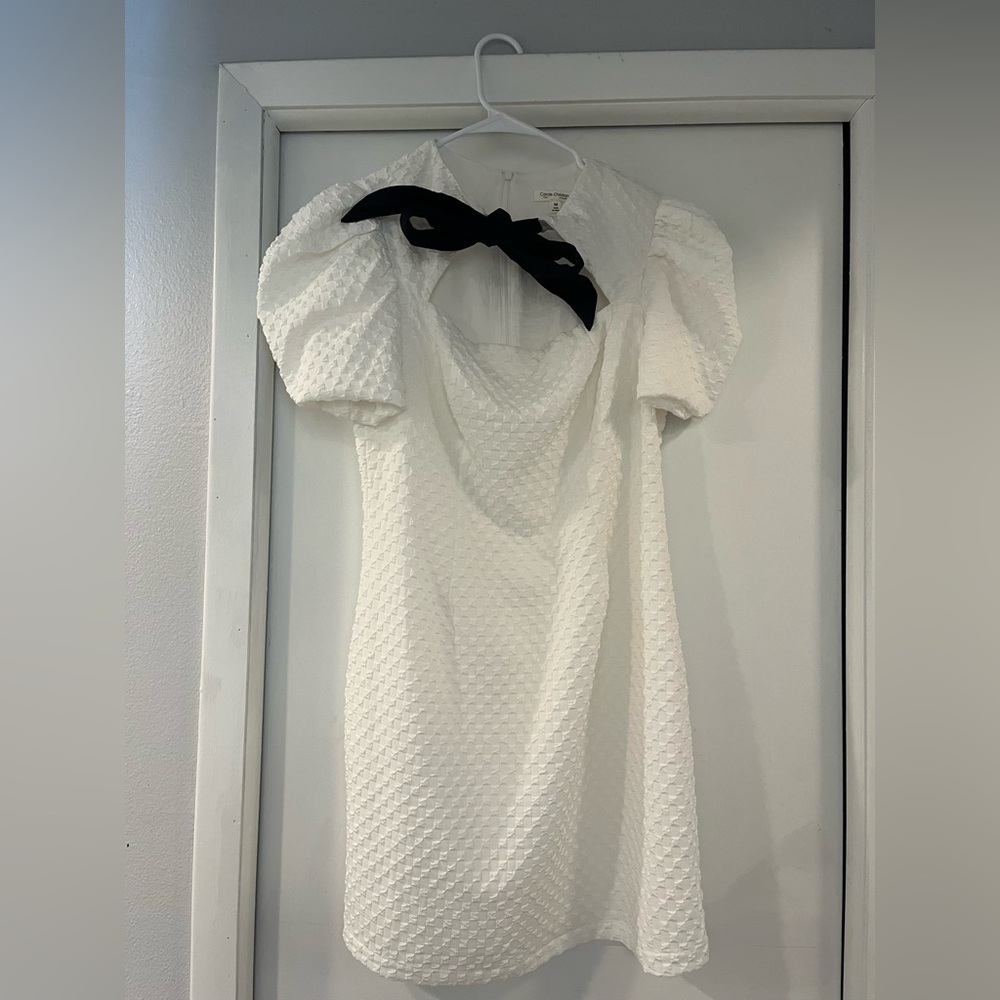 White mini dress with black bow